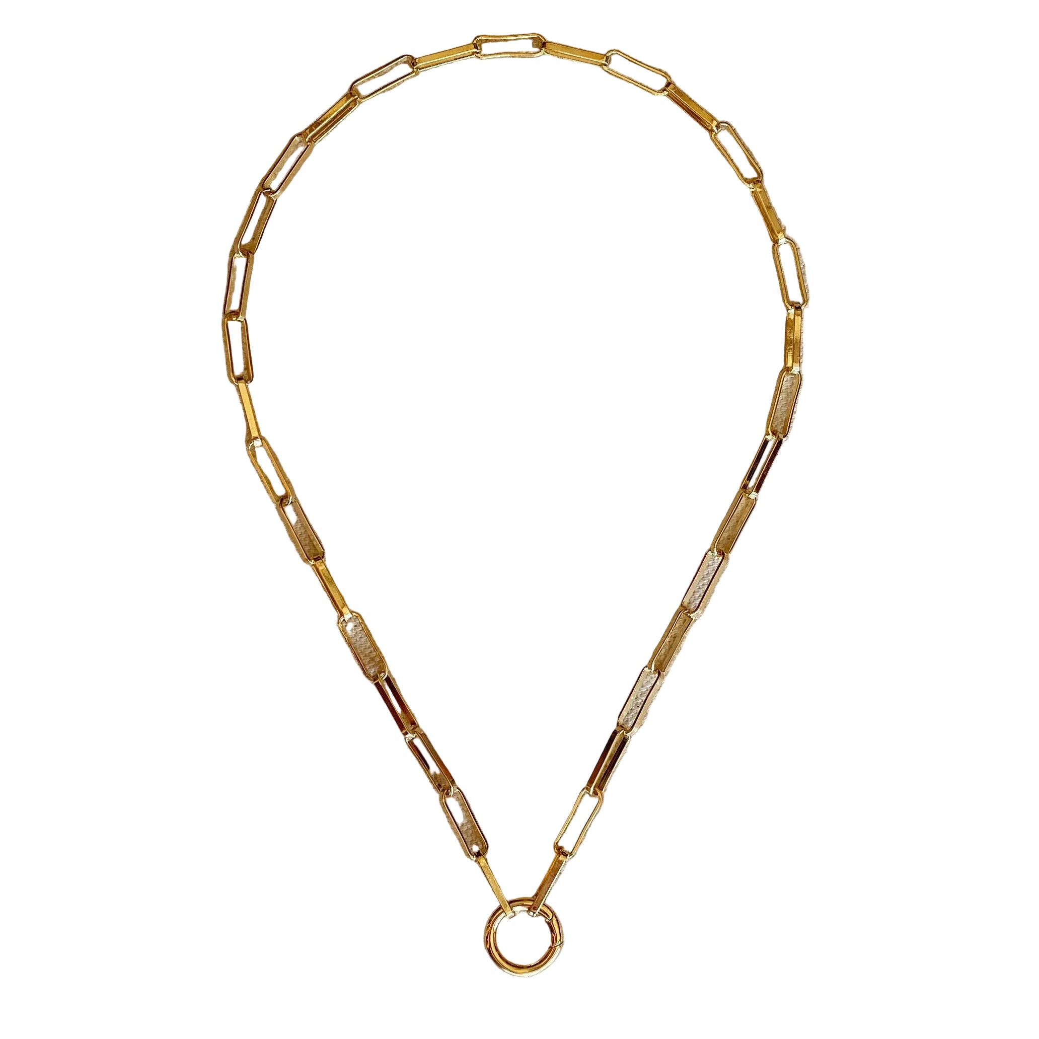 Gold necklace on a beige fabric background