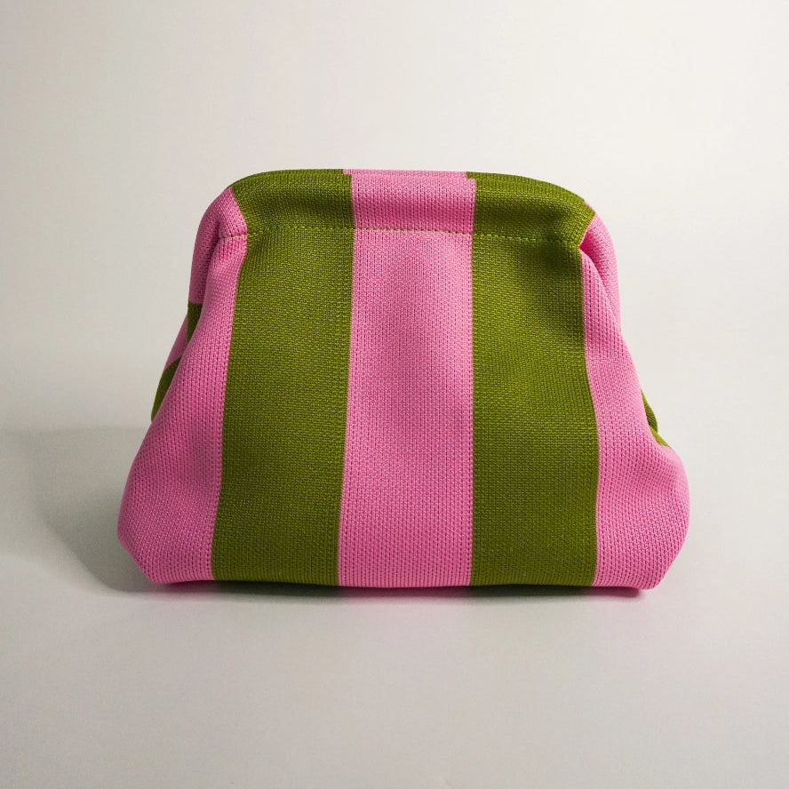 Pink and green striped fabric bag on a light gray background