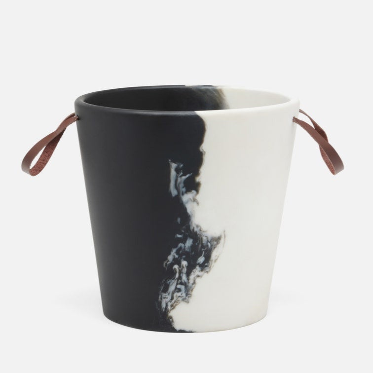 Black and white resin bucket with brown handles on a white background