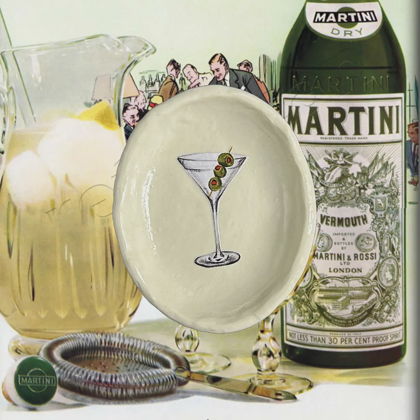 Vintage-style Martini bottle with a glass of ice and lemon, and a decorative plate with a cocktail illustration.