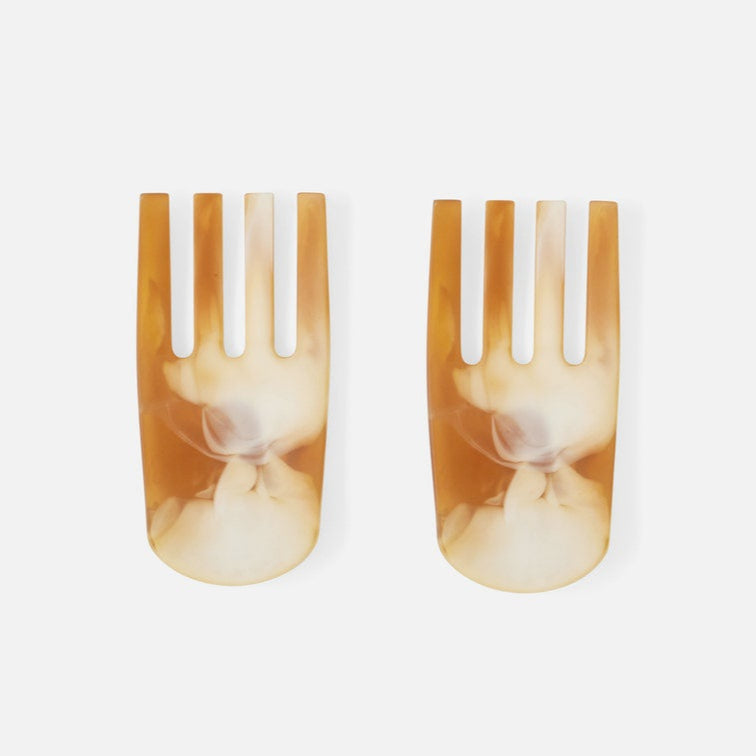 two salad servers on white background