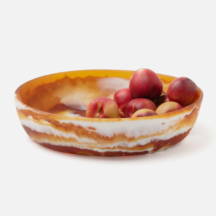 Decorative bowl with peaches on a white background