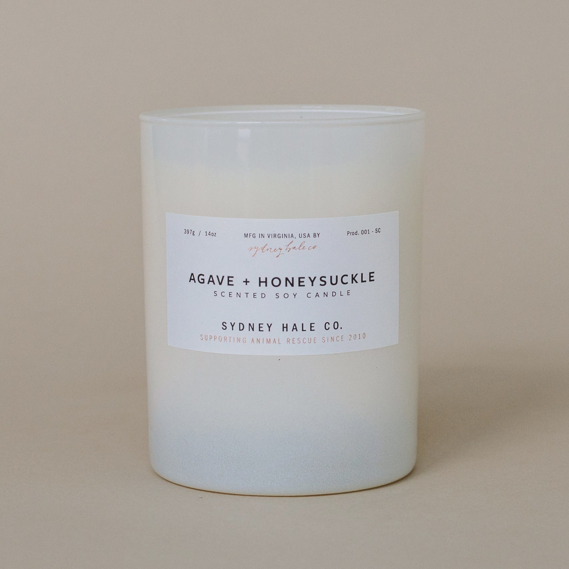 Candle with a label on a beige background