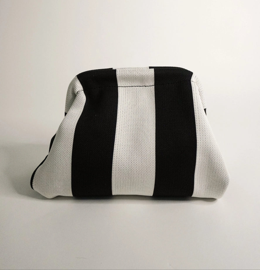 Black and white striped pouch on a light gray background
