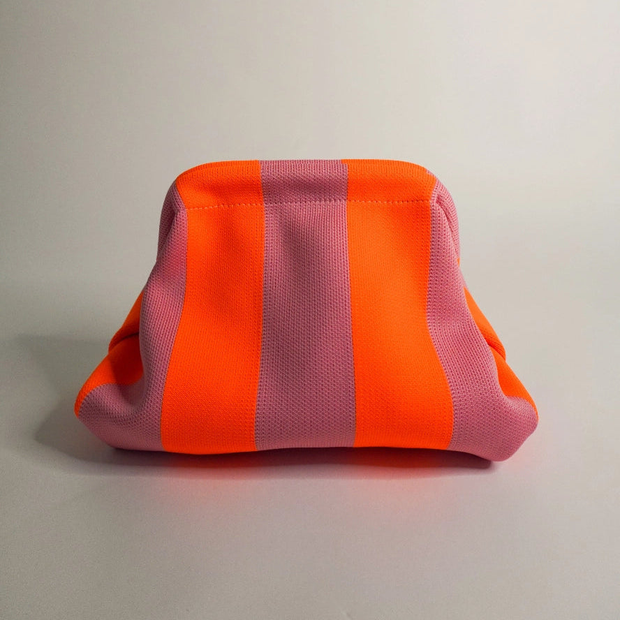 Pink and orange striped pouch on a light gray background