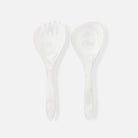 Two white resin spoons on a light gray background